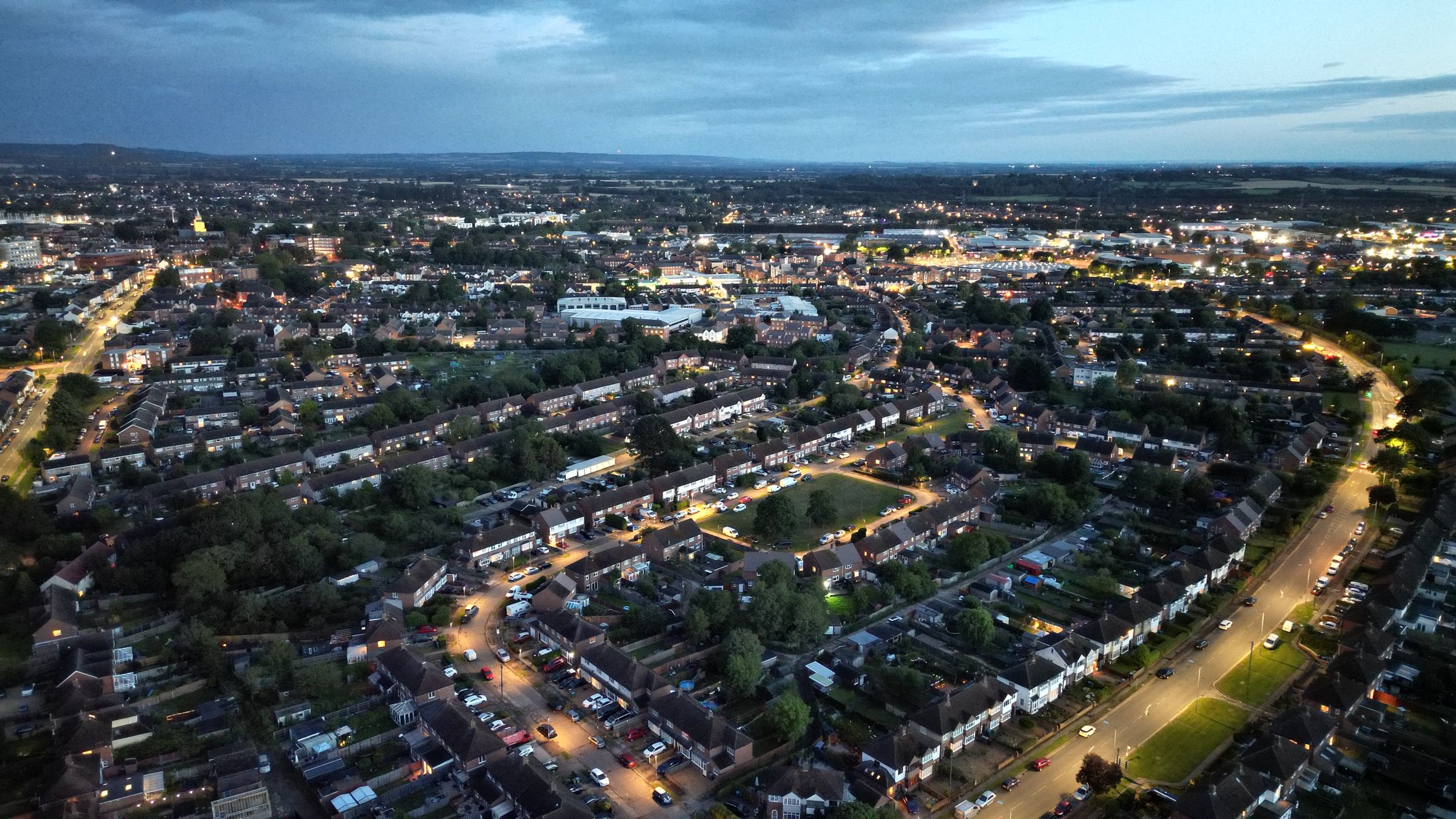 A town at dusk seen from the air, the whole development context in one view